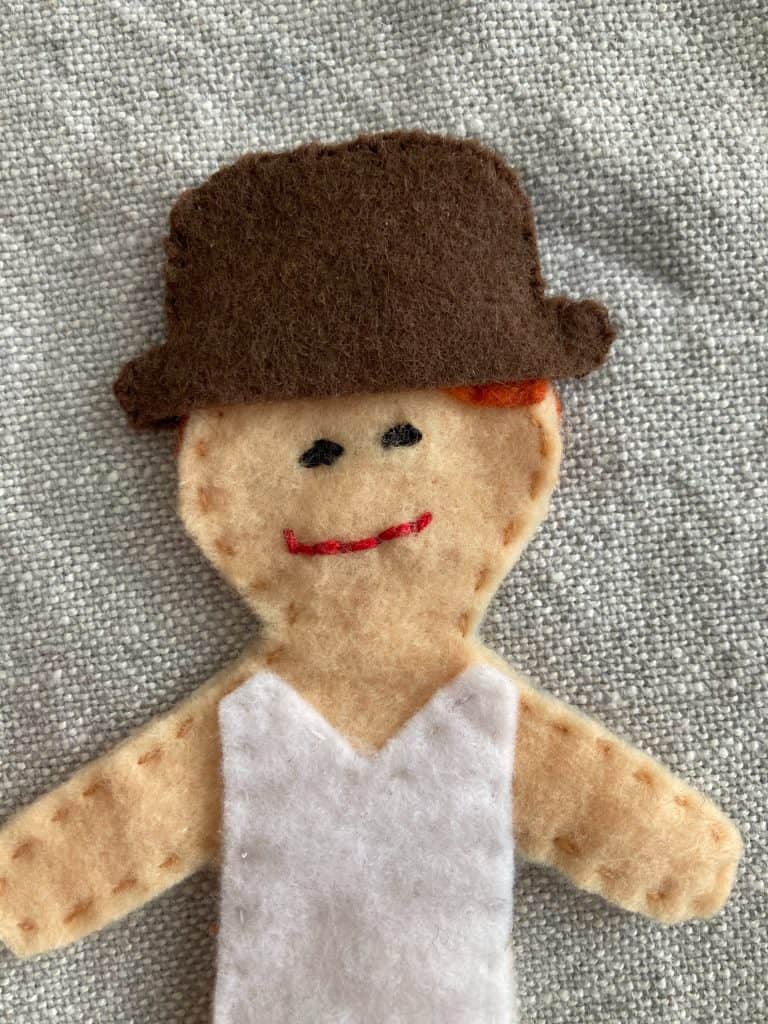 felt doll wearing a felt hat
