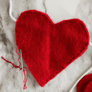 felt heart being hand stitched in progress
