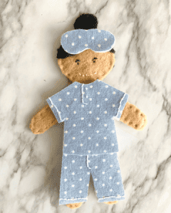 felt doll wearing blue polka dot pajamas