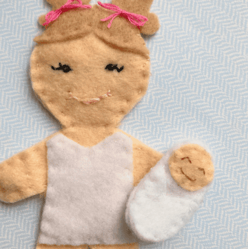 felt doll holding a magnetic felt baby